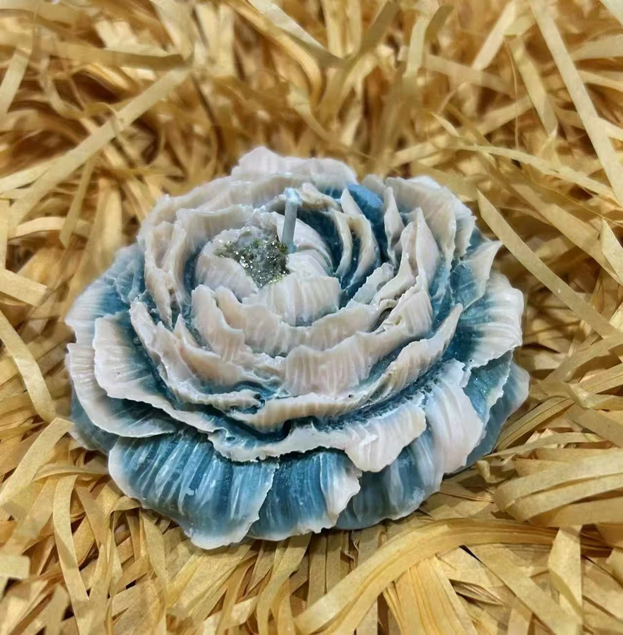Blue and white flower-shaped candle