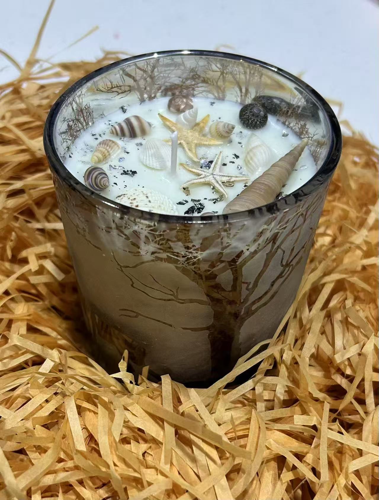 Ocean-themed candle with shells and starfish