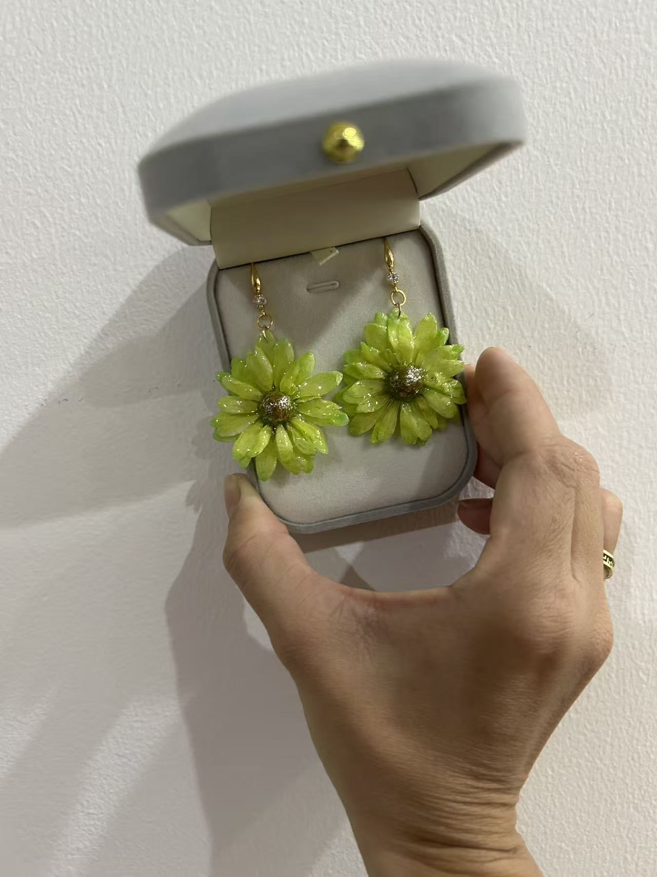 Green flower earrings in a jewelry box