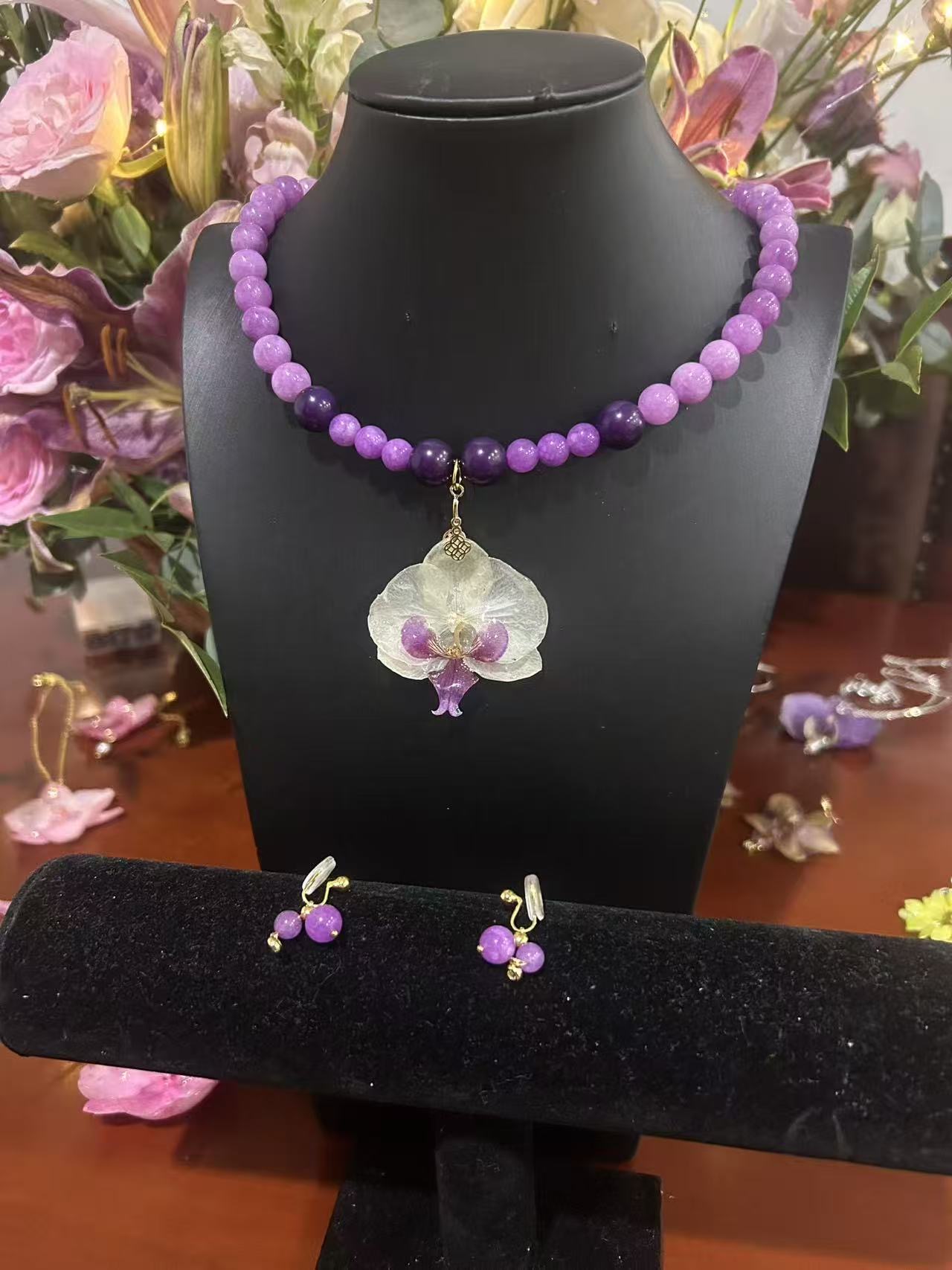 Purple beaded necklace with orchid pendant