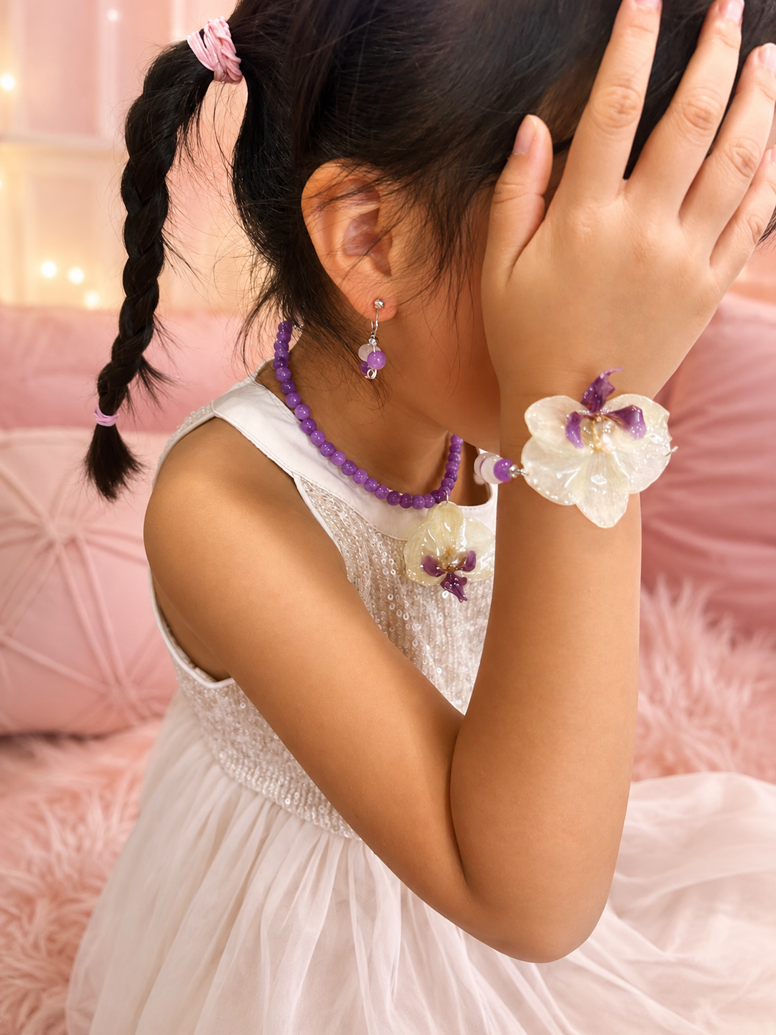 Child wearing a handmade orchid jewelry set